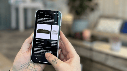 Hands holding a phone with ChatGPT open on the screen